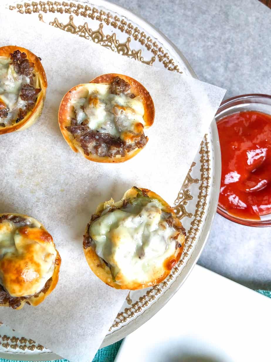 cheese steak wonton cups on a plate with ketchup on the side.