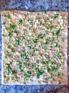 puff pastry sheet coated with garlic and herbs