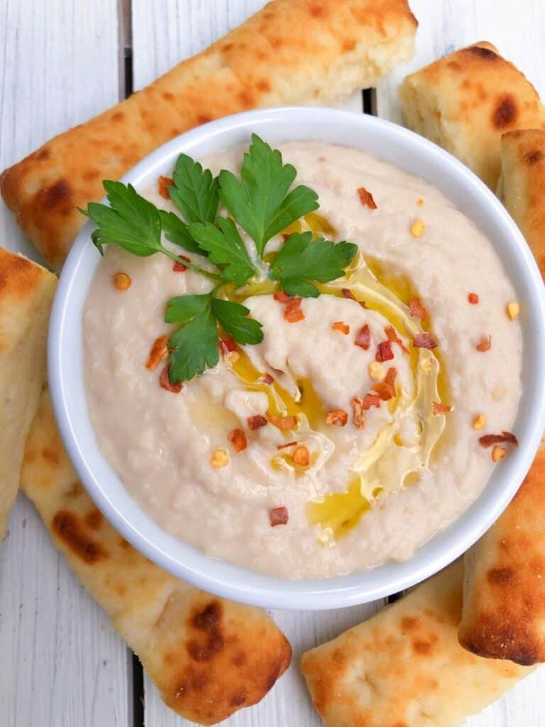 White bean dip in a bowl with olive oil.