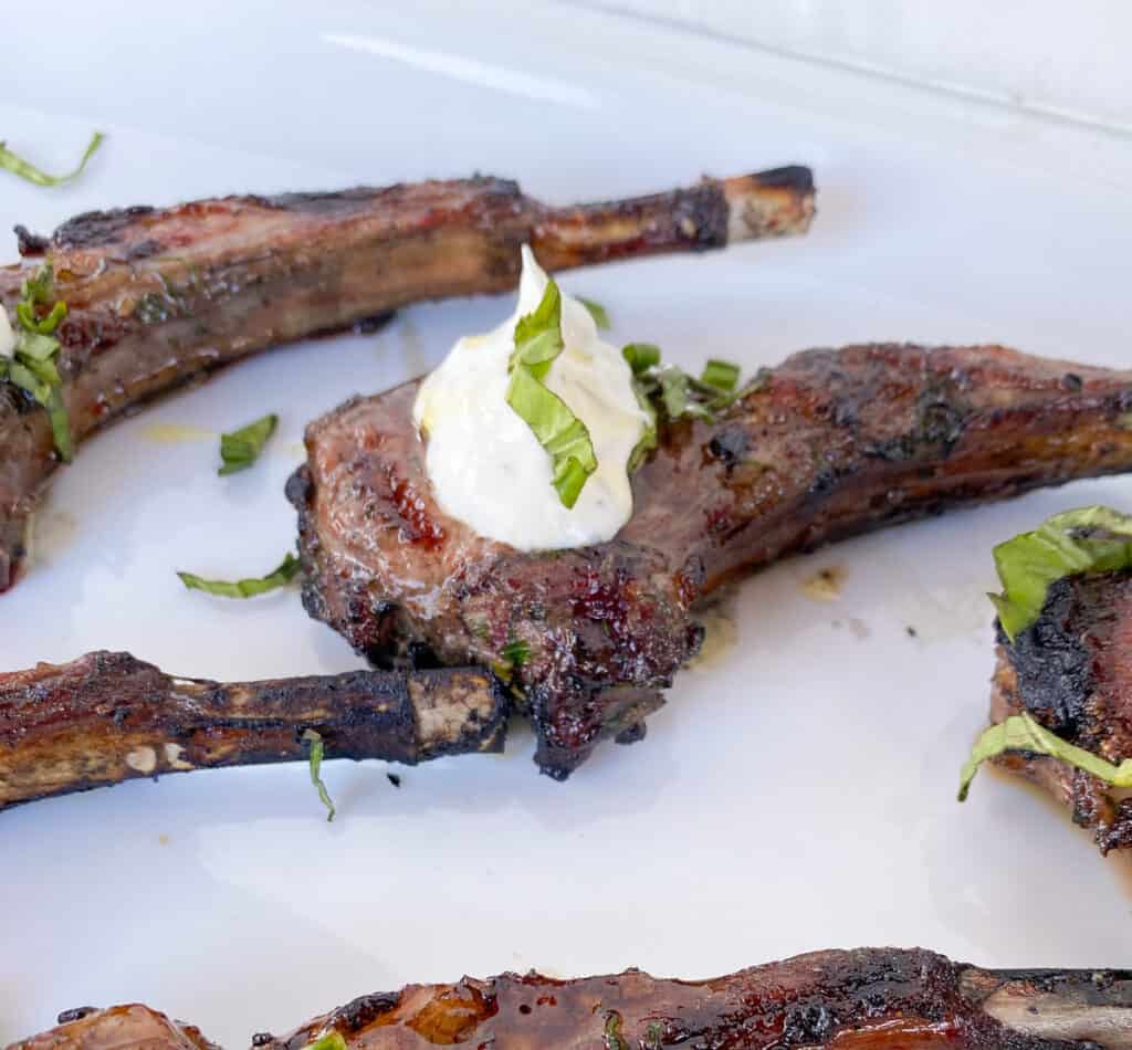 grilled lamb chops appetizer with greek yogurt on top