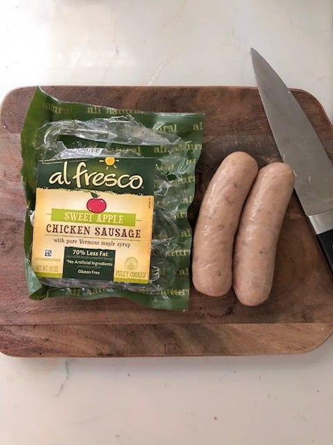 Al fresco chicken sausage in package on cutting board.