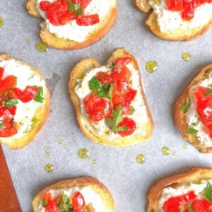 crostini appetizer on a plate with ricotta cheese and peppers
