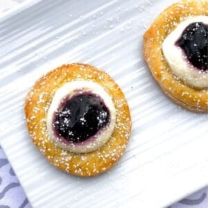 crescent dough rounds topped with sweet cream cheese and blueberries