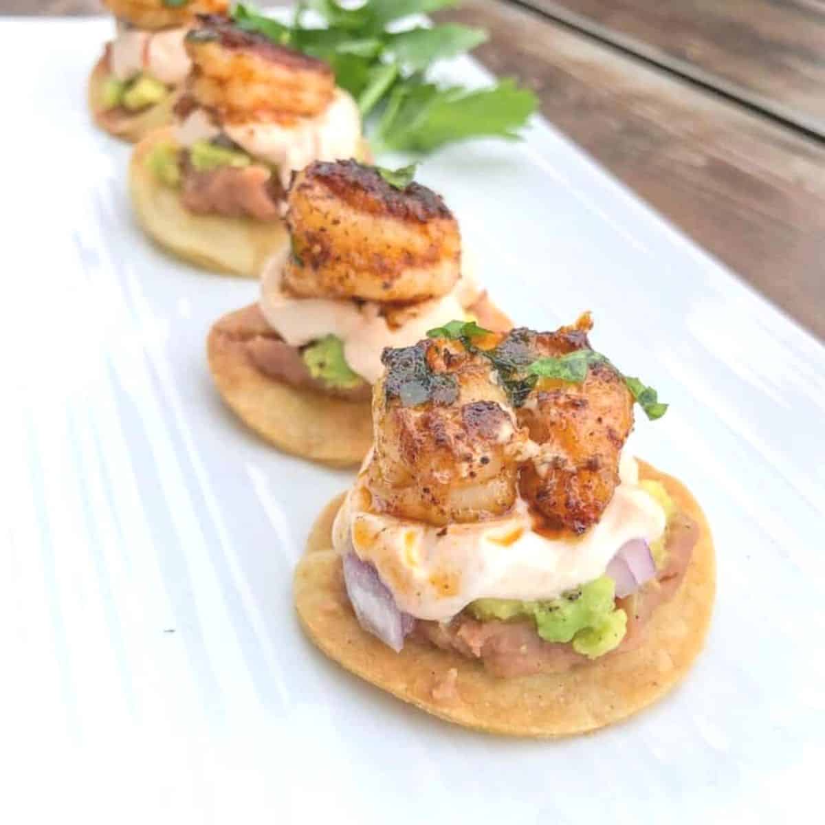 mini shrimp tostadas bites lined on a plate
