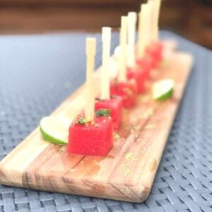 watermelon skewers on a wooden board