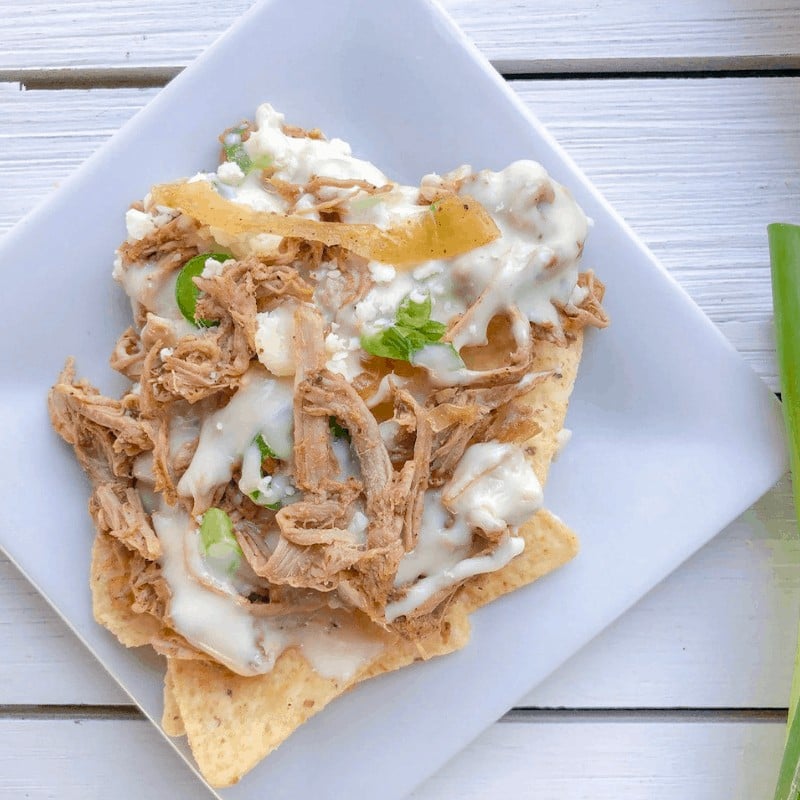 Serving of pulled pork nachos on a plate.