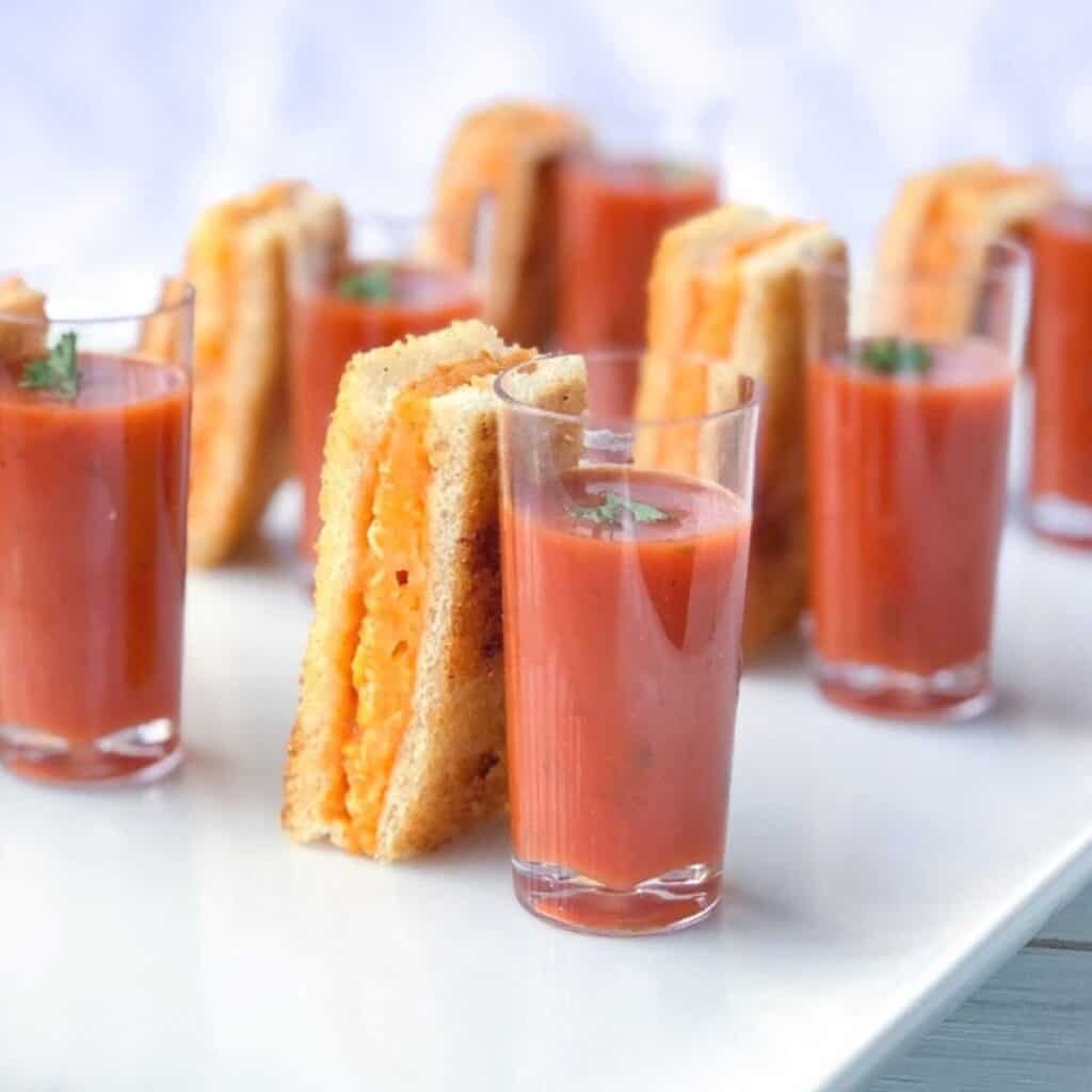 Baked grilled cheese sticks with tomato soup shooter.