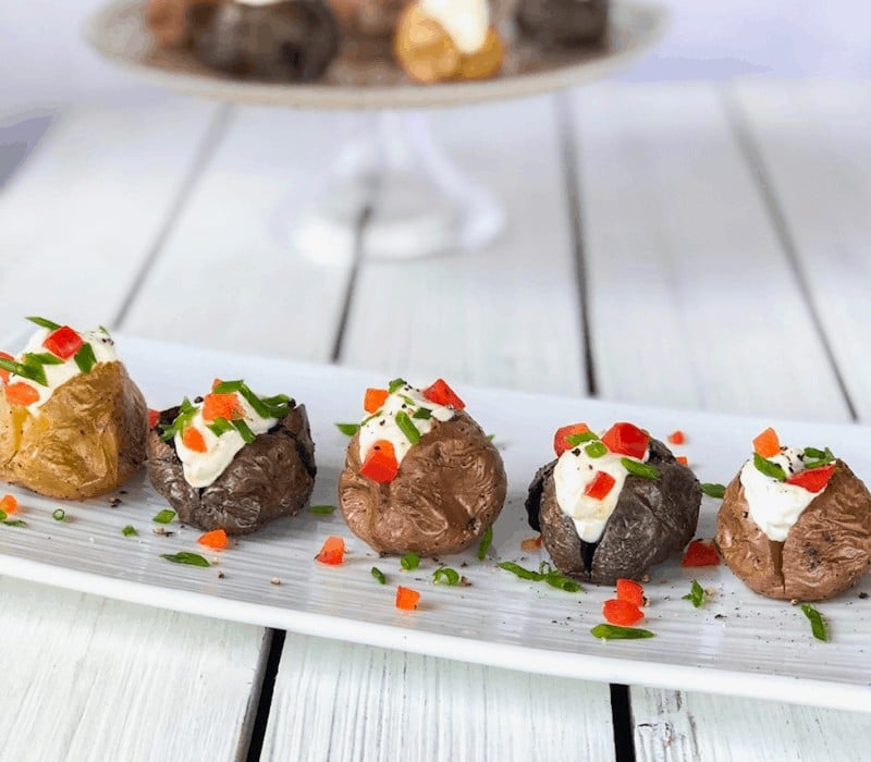 Mini baked potatoes stuffed with sour cream and chives.