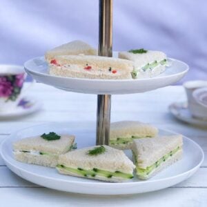 Tiered serving platter with English tea finger sandwiches.