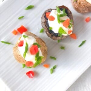 Mini baked potatoes stuffed with sour cream.