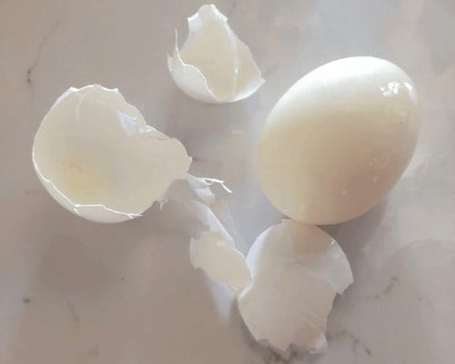 A hard boiled egg peeled.