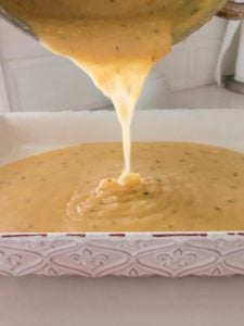 Pouring polenta into dish.