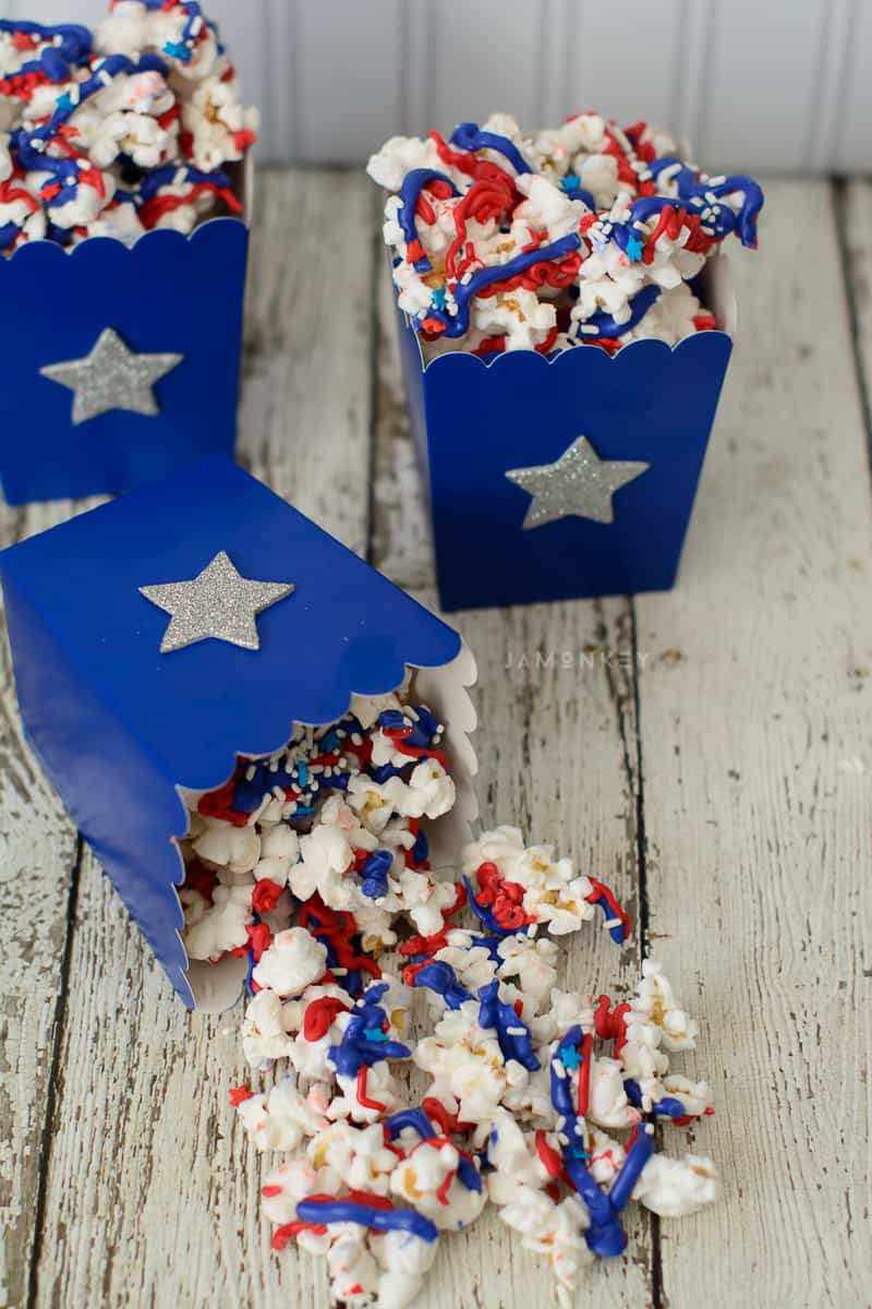 Red white and blue popcorn spilled on table.