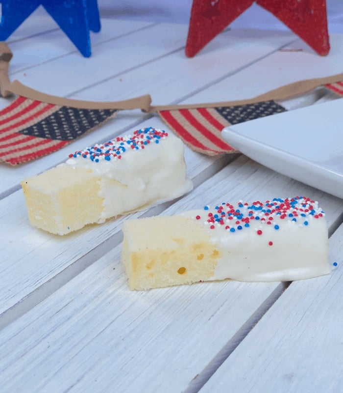 Cake sticks dipped in white chocolate sprinkled with red, white and blue nonpareils.