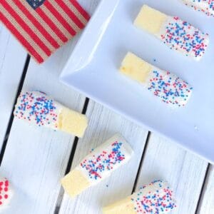 Cake sticks coated in red white and blue sprinkles.