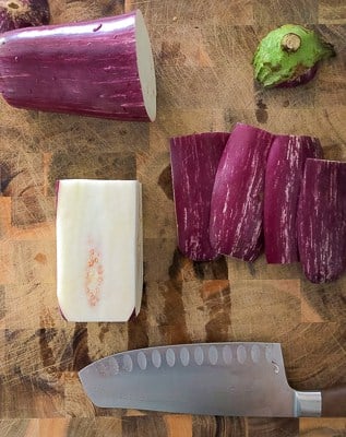 Showing how to cut an eggplant into french fries.