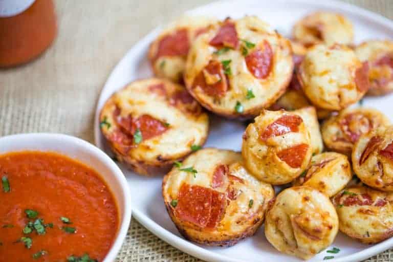 mini pizzas with pepperoni on top.
