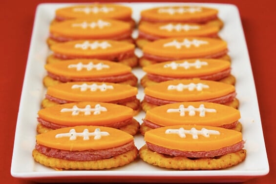 cheese cut into shapes of football and served over a crackers with sausage.