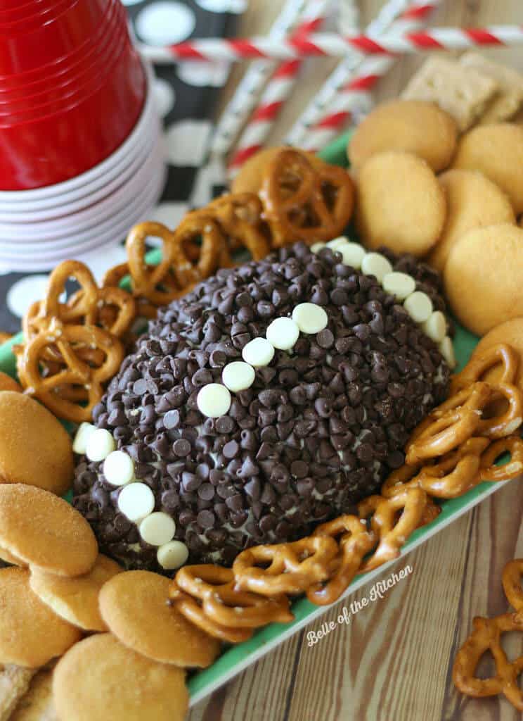 a cheesecake mold shaped into a football coated with chocolate chips.