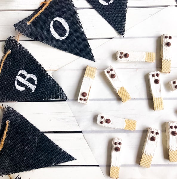 Chocolate dipped wafers with chocolate chips that resemble ghosts.