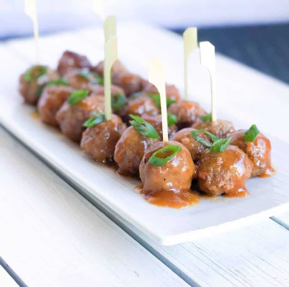 Sweet and sour slow cooker meatballs skewered.