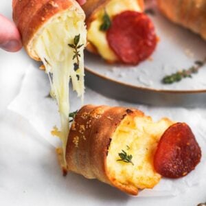 Pizza cone on table with cheese oozing out.