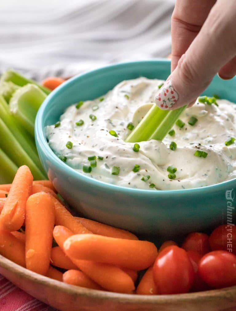 Garlic and veggie cold dip with sour cream and veggies on the side.