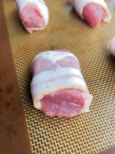 Raw pork cubes wrapped in bacon strips.