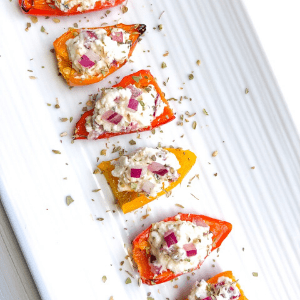 mini peppers stuffed with feta cheese on white plate