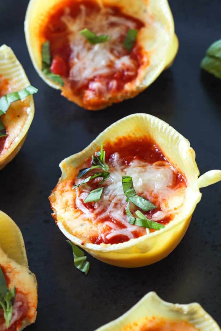 Reverse shell stuffed with cheese, marinara topped garnished with basil.