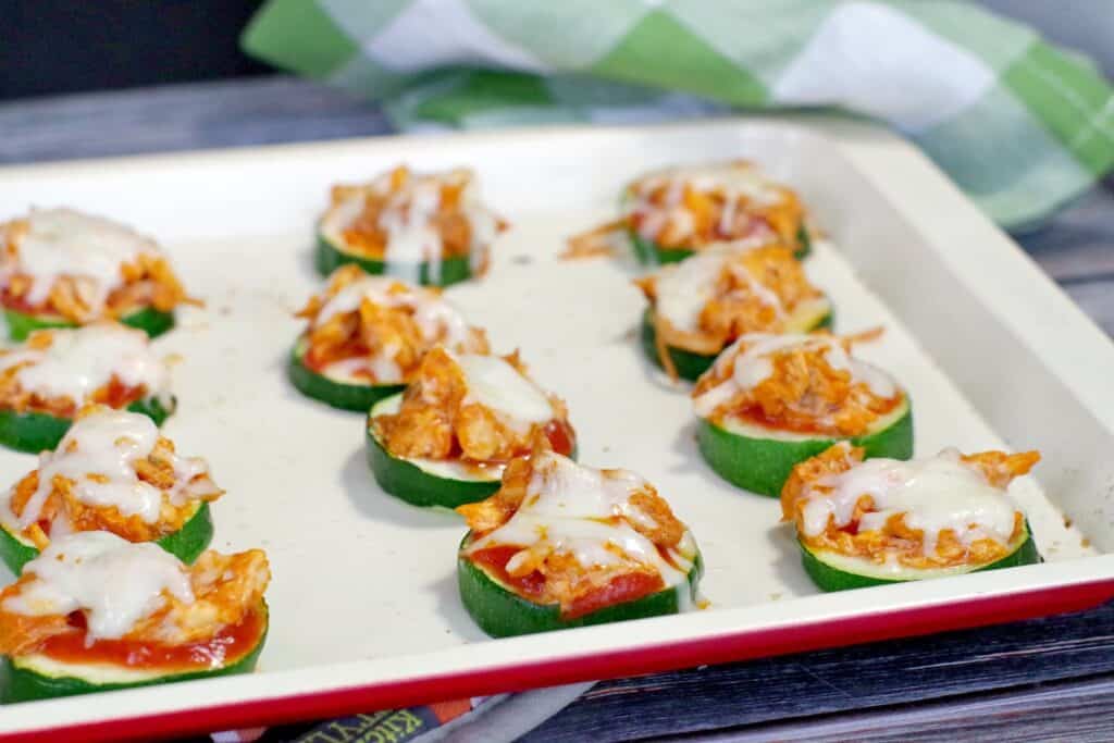 buffalo zucchini appetizers on rounds with melted cheese on top
