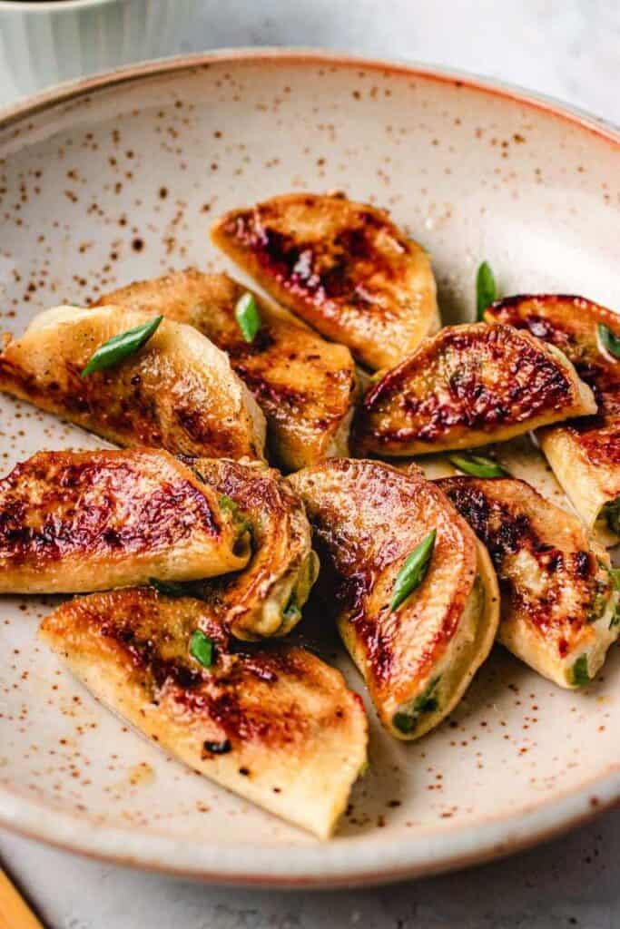 appetizer potstickers with sauce in a bowl