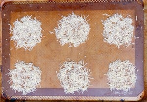 shredded cheese in circles on a nonstick sheet