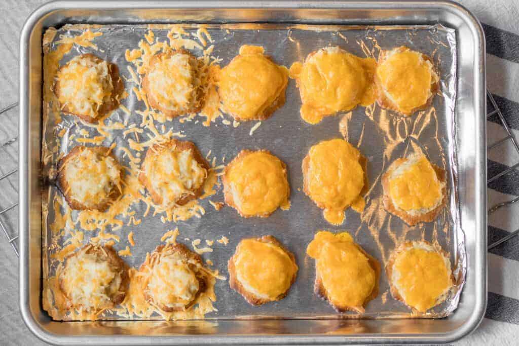 tuna melt bites on a baking sheet with melted cheese