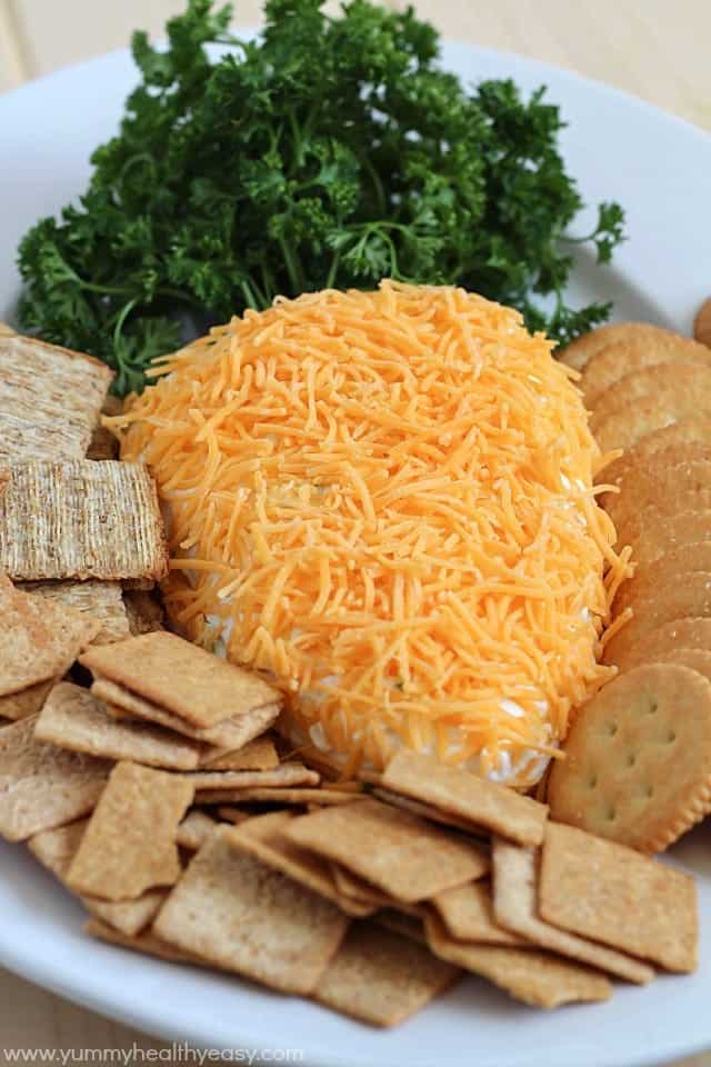 cream cheese shaped into a carrot with crackers around it.