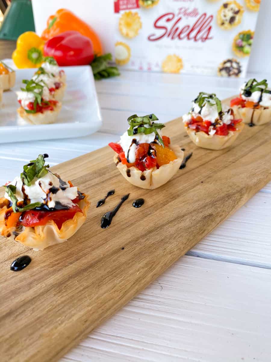 phyllo cups finger food stuffed with peppers and burrata cheese.