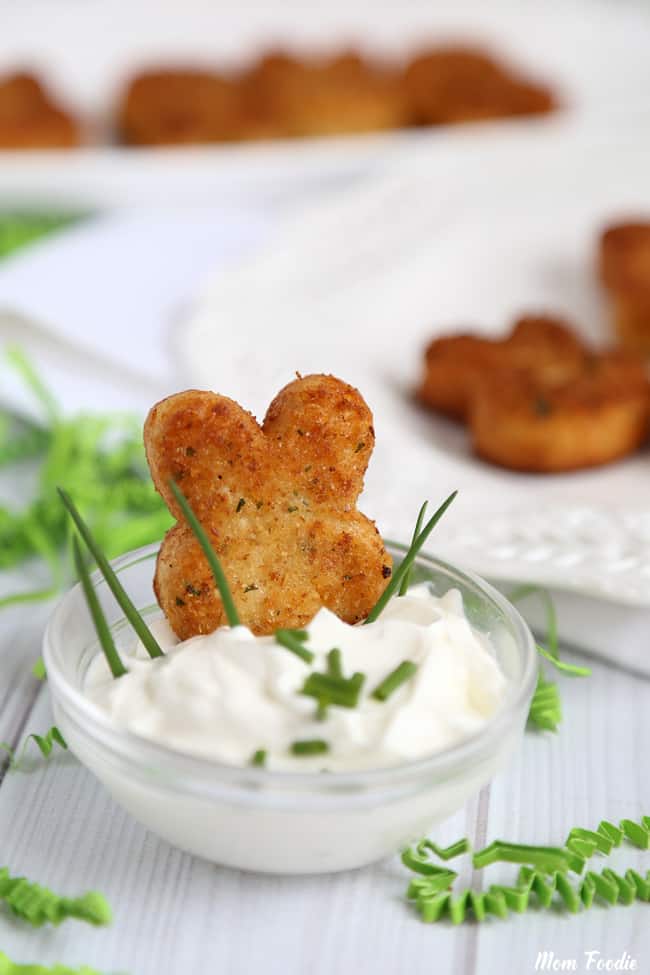 mini Easter bunny croquettes appetizer sitting in a bowl of sour cream.