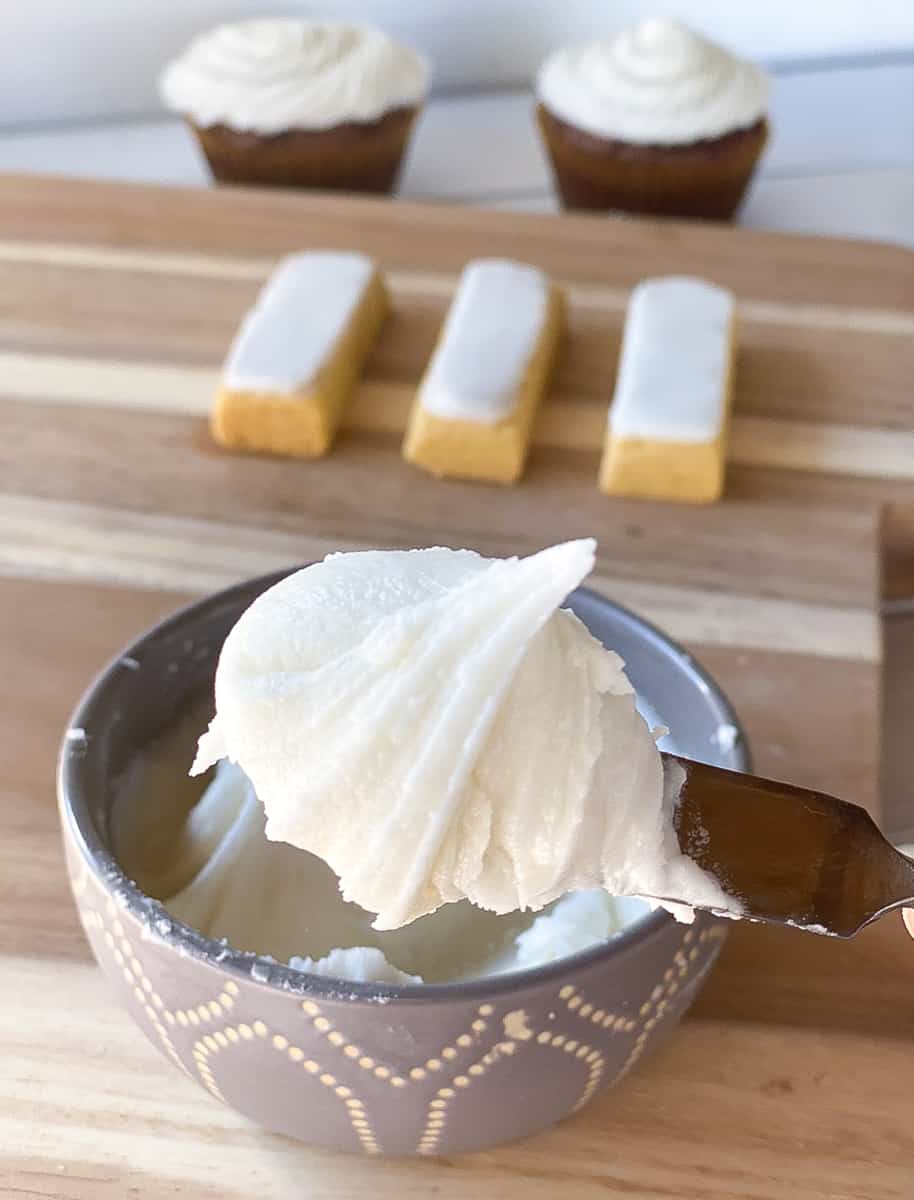 Closeup of vanilla frosting with confectioners sugar and without butter in a bowl.