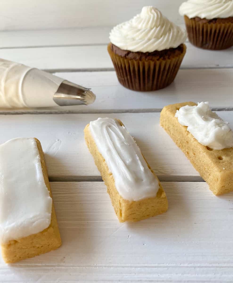 Vanilla powdered sugar frosting on cookies and chocolate cupcakes.