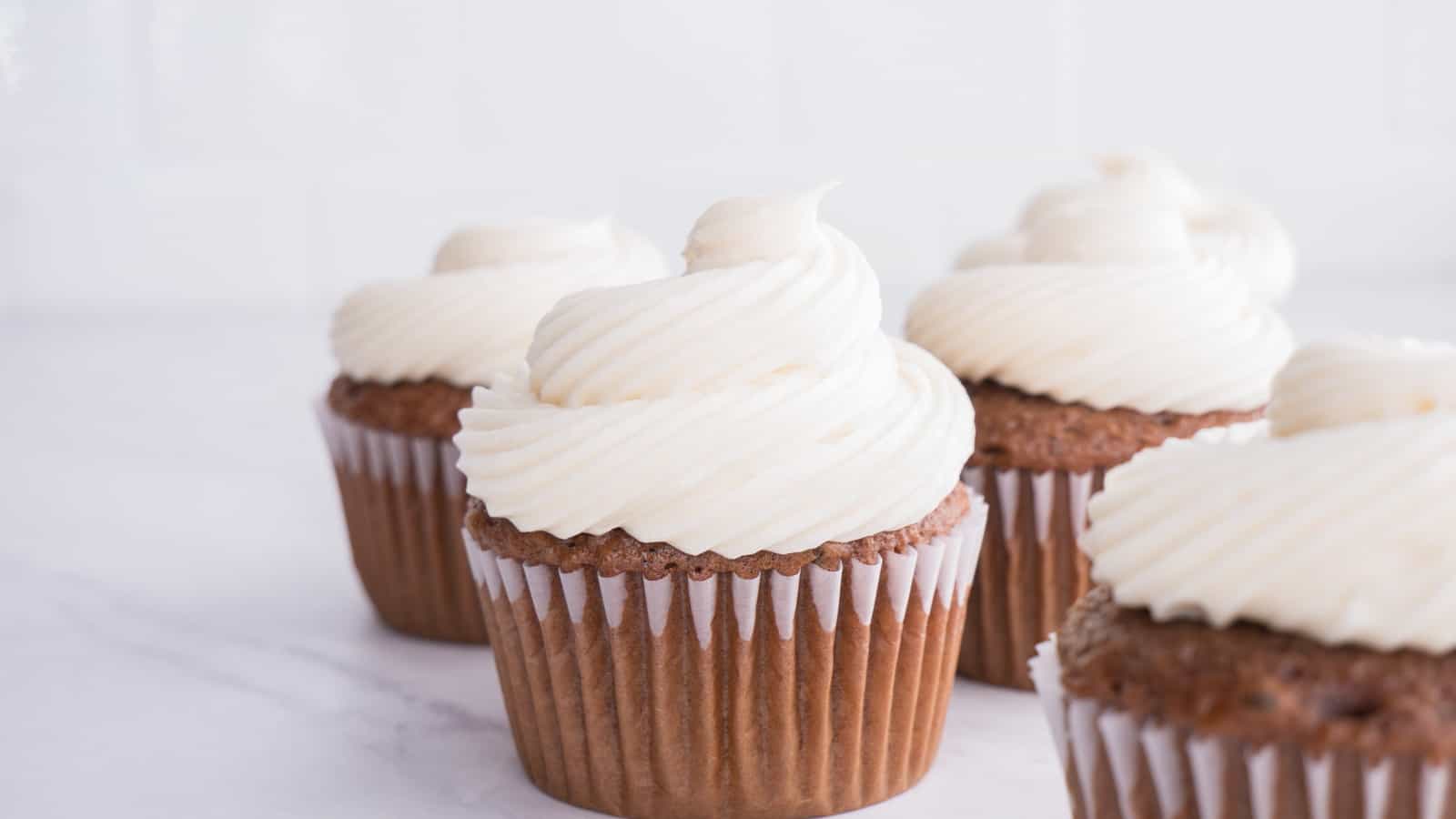 Chocolate cupcakes with white powdered sugar frosting without butter.