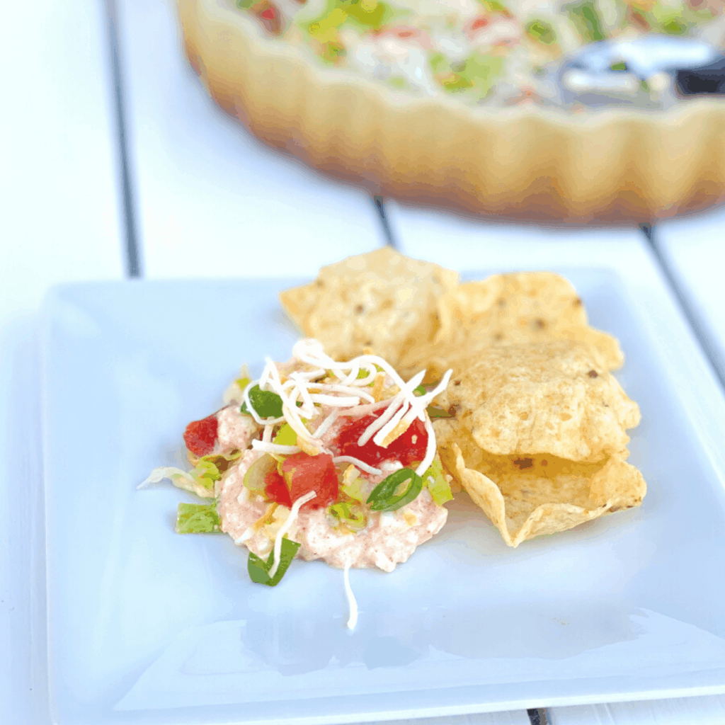 cottage cheese taco dip with tortilla chips on a plate