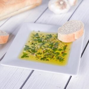 olive oil dip with fresh herbs on a plate