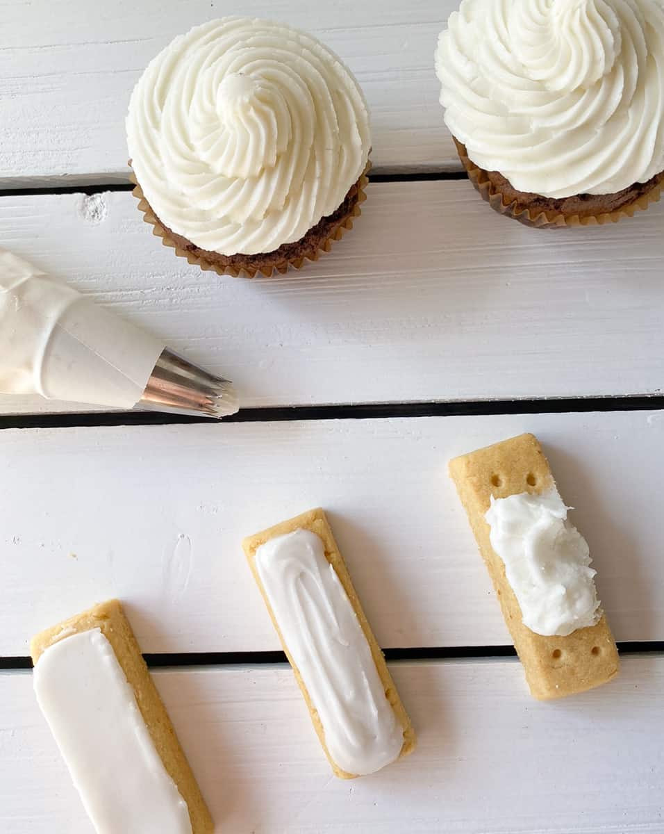 cookies and cupcakes frosted in a powdered sugar frosting.