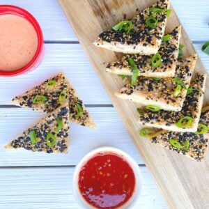 shrimp toast triangles on a table with sauces