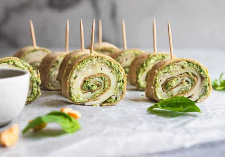 turkey and pesto pinwheels with a toothpick on a plate