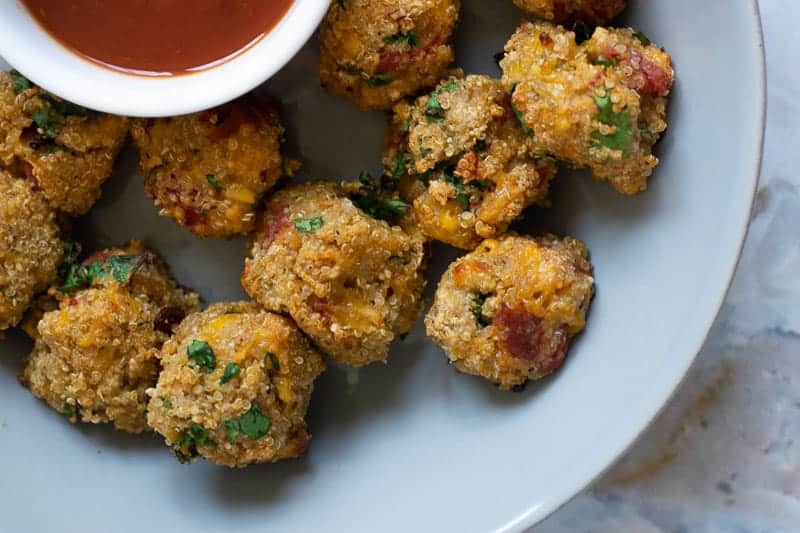 pizza quinoa bites with sauce on the side.