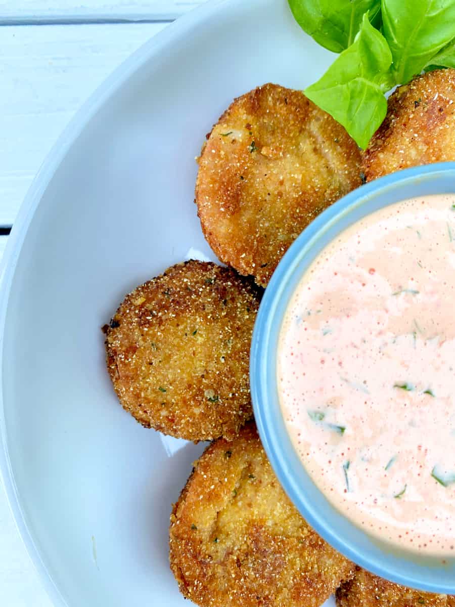 Fried red tomatoes with red pepper dipping sauce in the middle.