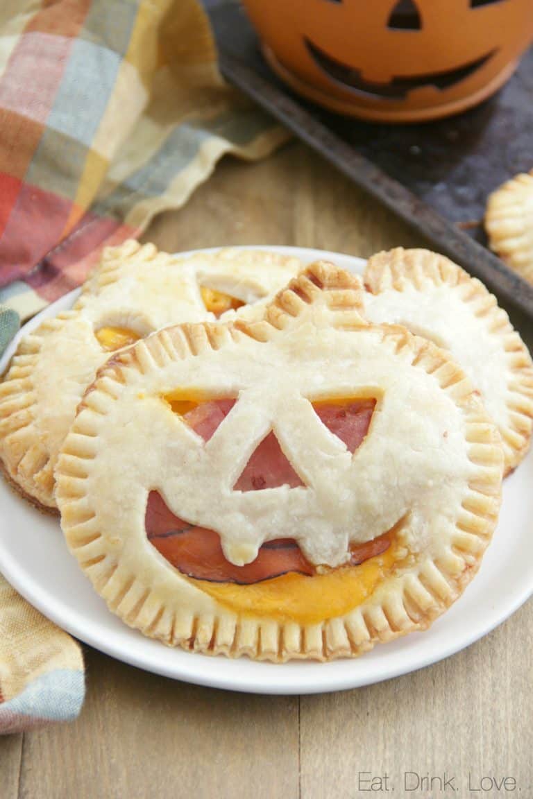 Jack-0-lantern ham and cheese pie appetizer on a plate.