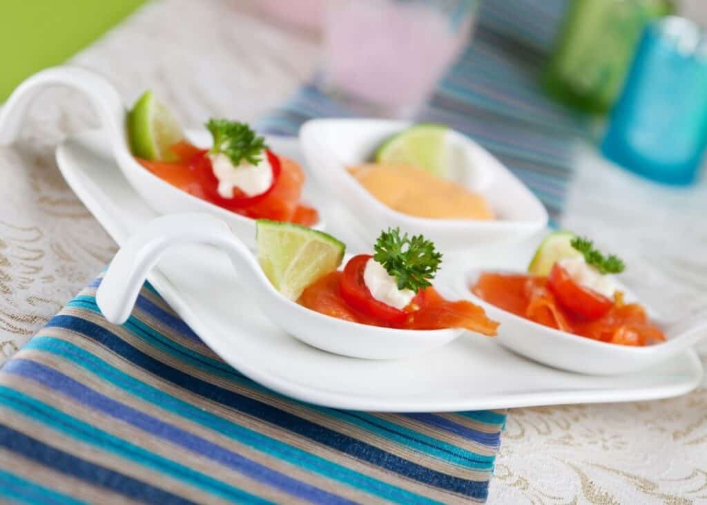 Amuse bouche soup spoons on a plate .