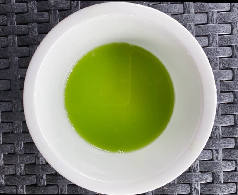 Excess water from a cucumber in a bowl.